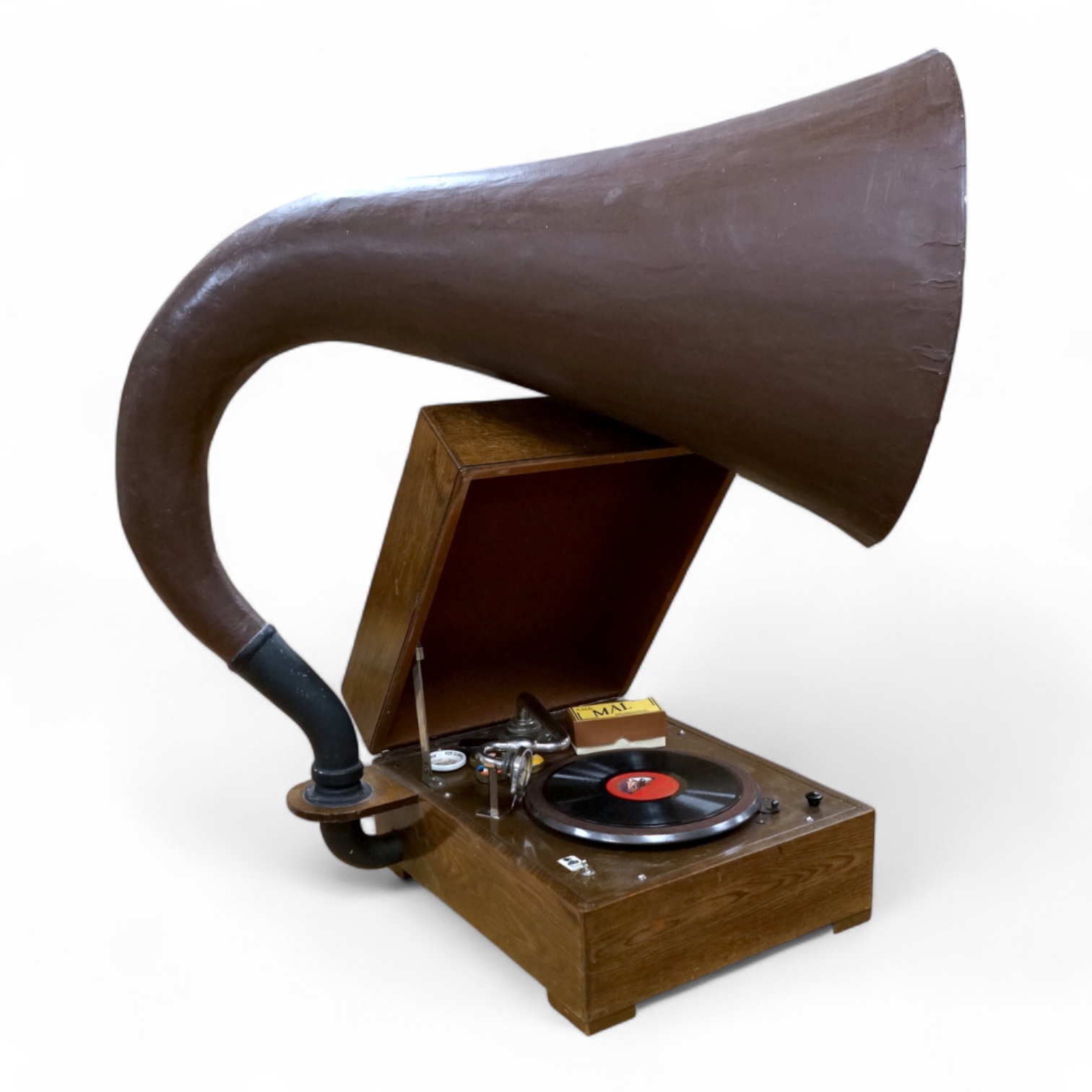 An EMG ‘Handmade Gramophone’ with electrically powered motor, in an oak veneered case with large papier-mâché horn, dimensions of the case; 44 x 53 x 27cm, diameter of the horn 56cm.
